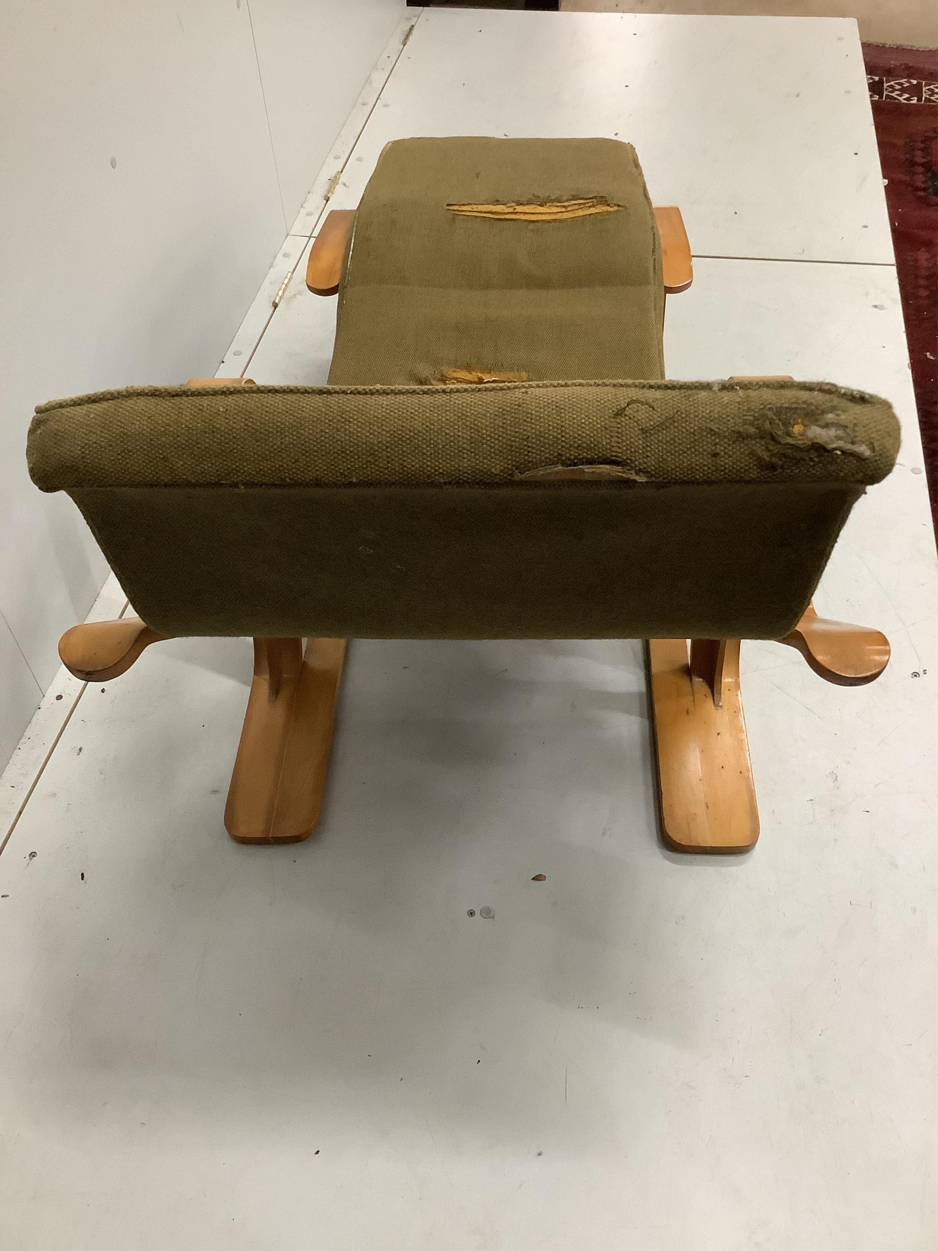After Marcel Breuer, a bent ply long chair, circa 1960, width 134cm, depth 65cm, height 81cm. Condition - original upholstery now in need of replacement or removal, frame fair